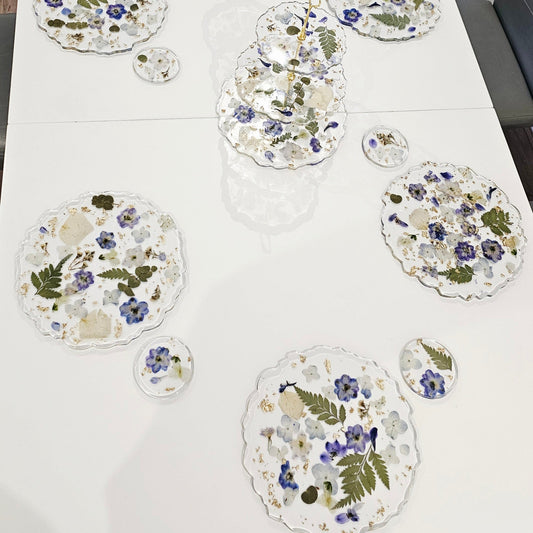 Floral placemats on a white tablecloth with chairs around