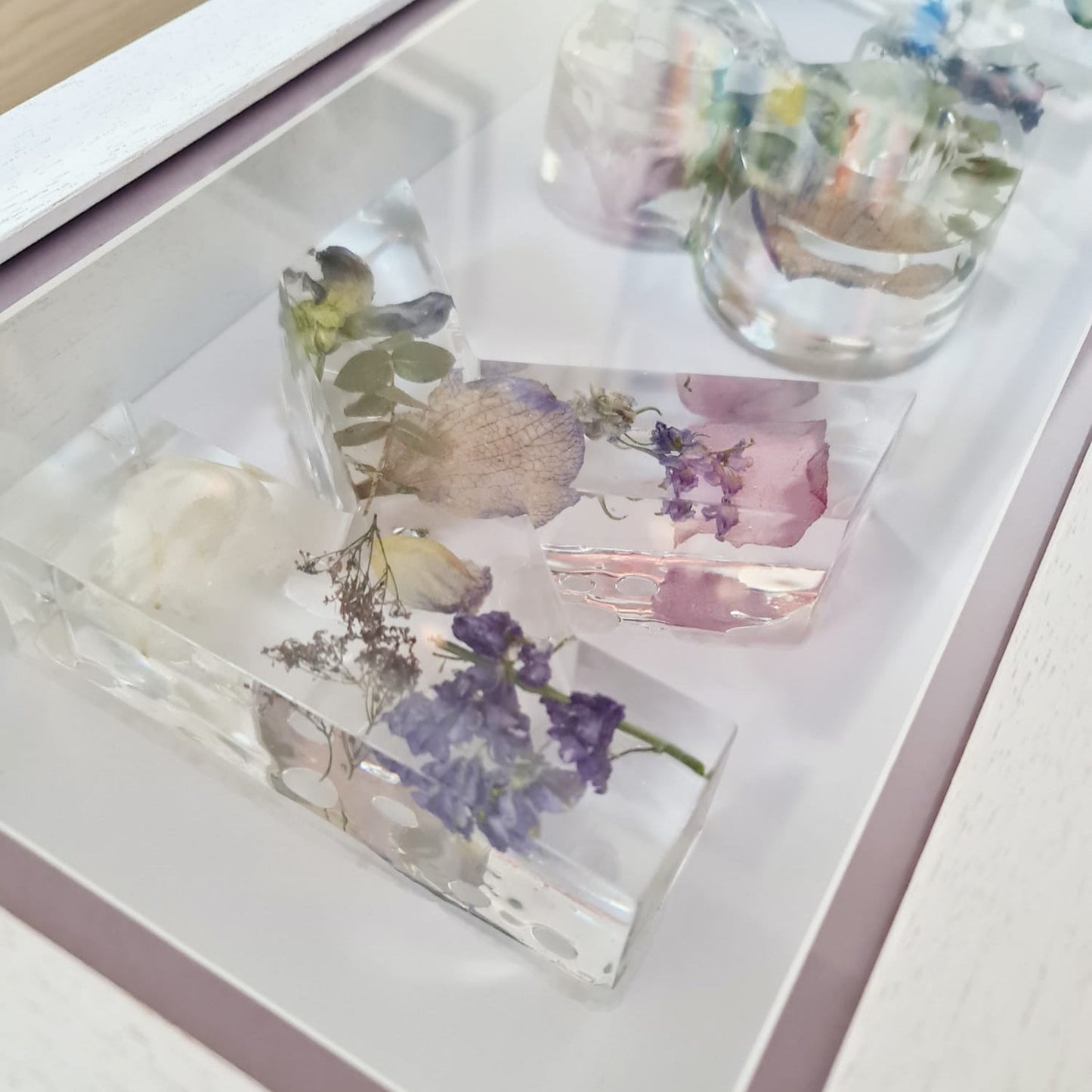 Decorative glass pieces with floral designs on a white surface