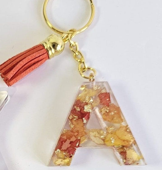 Keychain with letter 'A' design and tassel on a white background