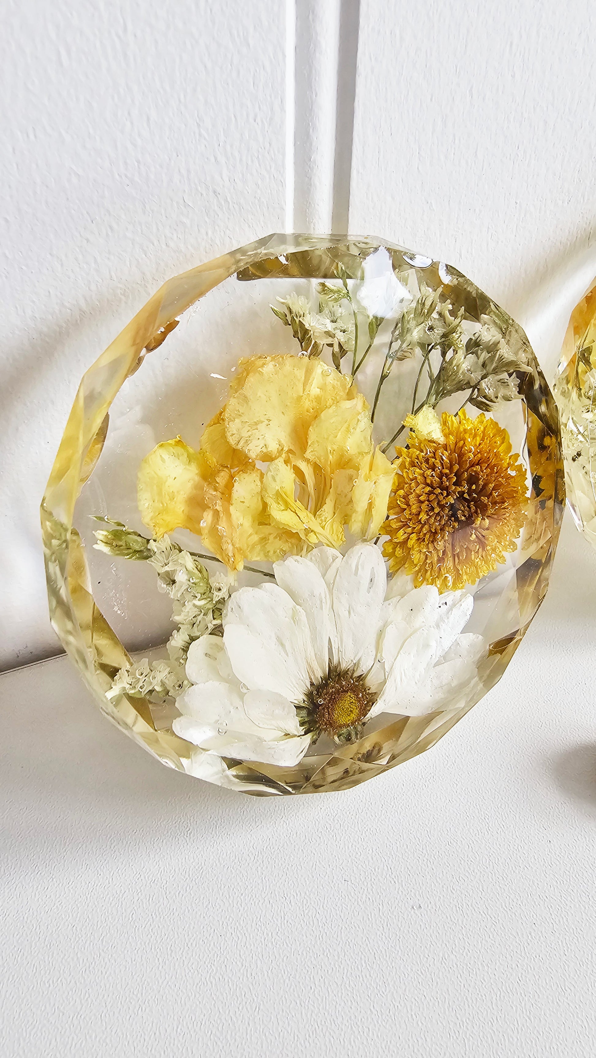 A stunning faceted-edge resin disk showcasing yellow preserved flowers in crystal-clear resin. Each petal and stem is captured in perfect detail, creating a timeless keepsake ideal for wedding bouquet preservation or funeral flower memorials.