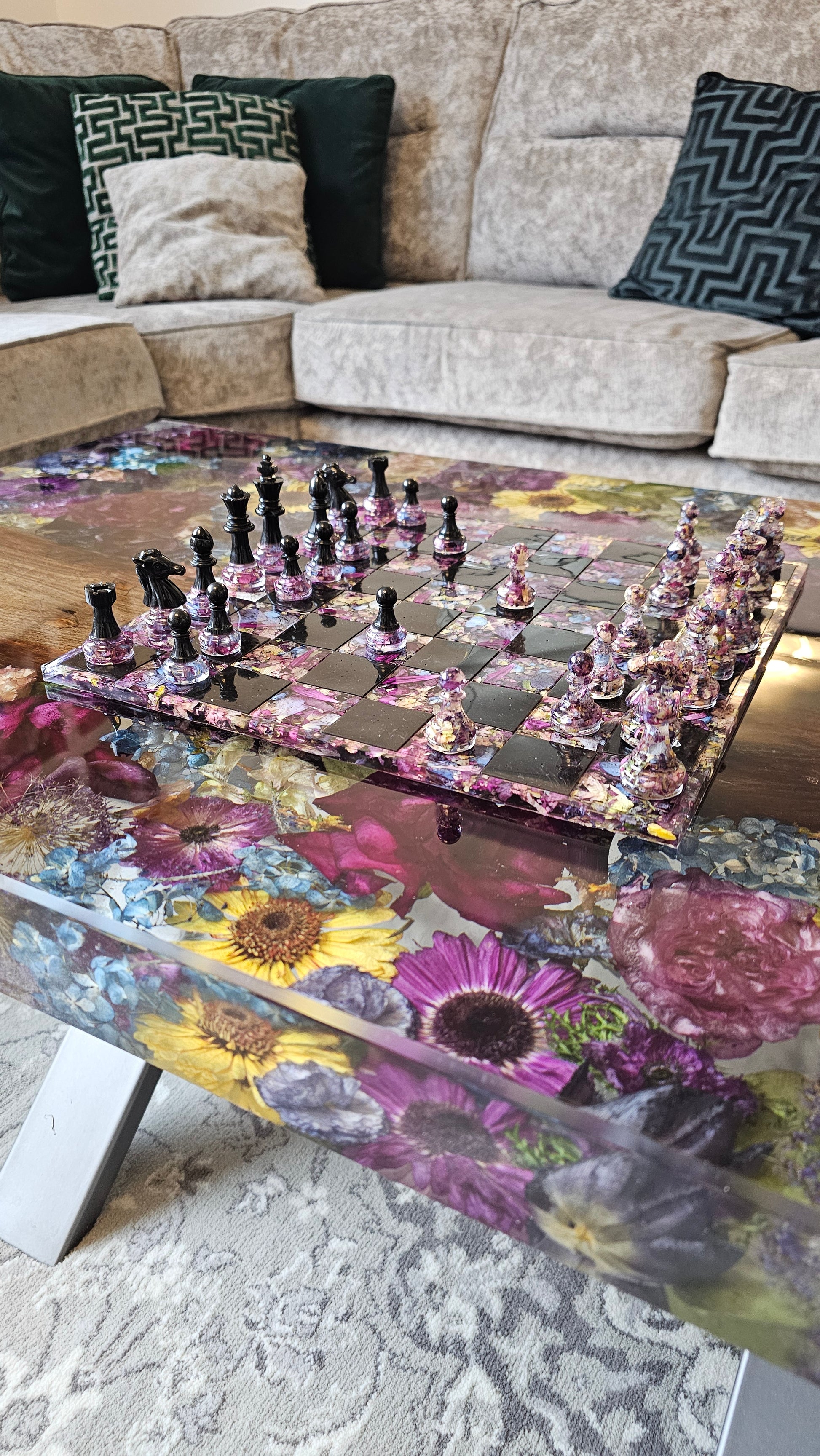 Flowers preserved in a resin coffee table with a resin flower preservation chess board placed ontop
