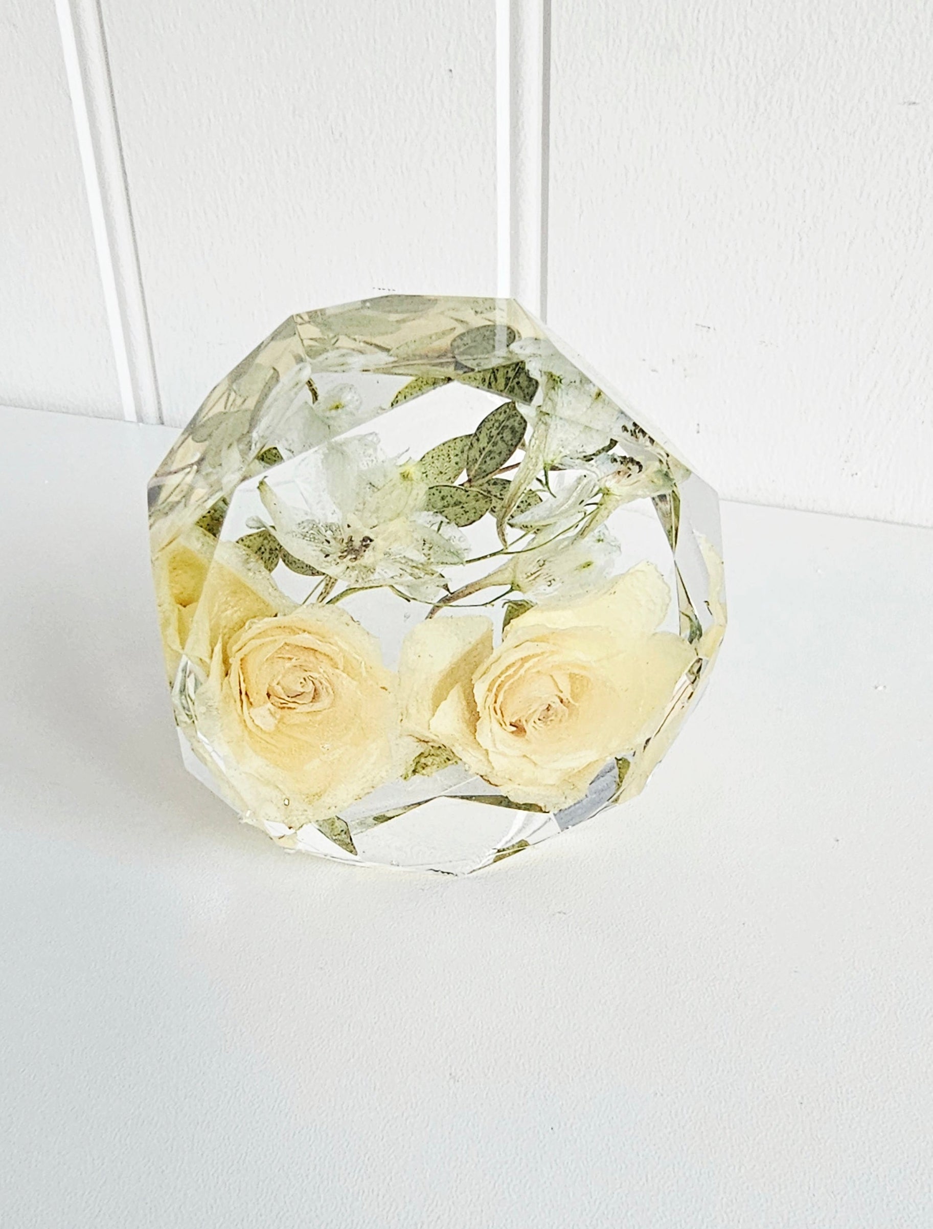 Crystal geometric resin flower preservation paperweight with preserved yellow roses on a white background