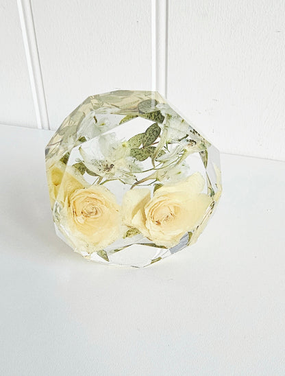 Crystal geometric resin flower preservation paperweight with preserved yellow roses on a white background