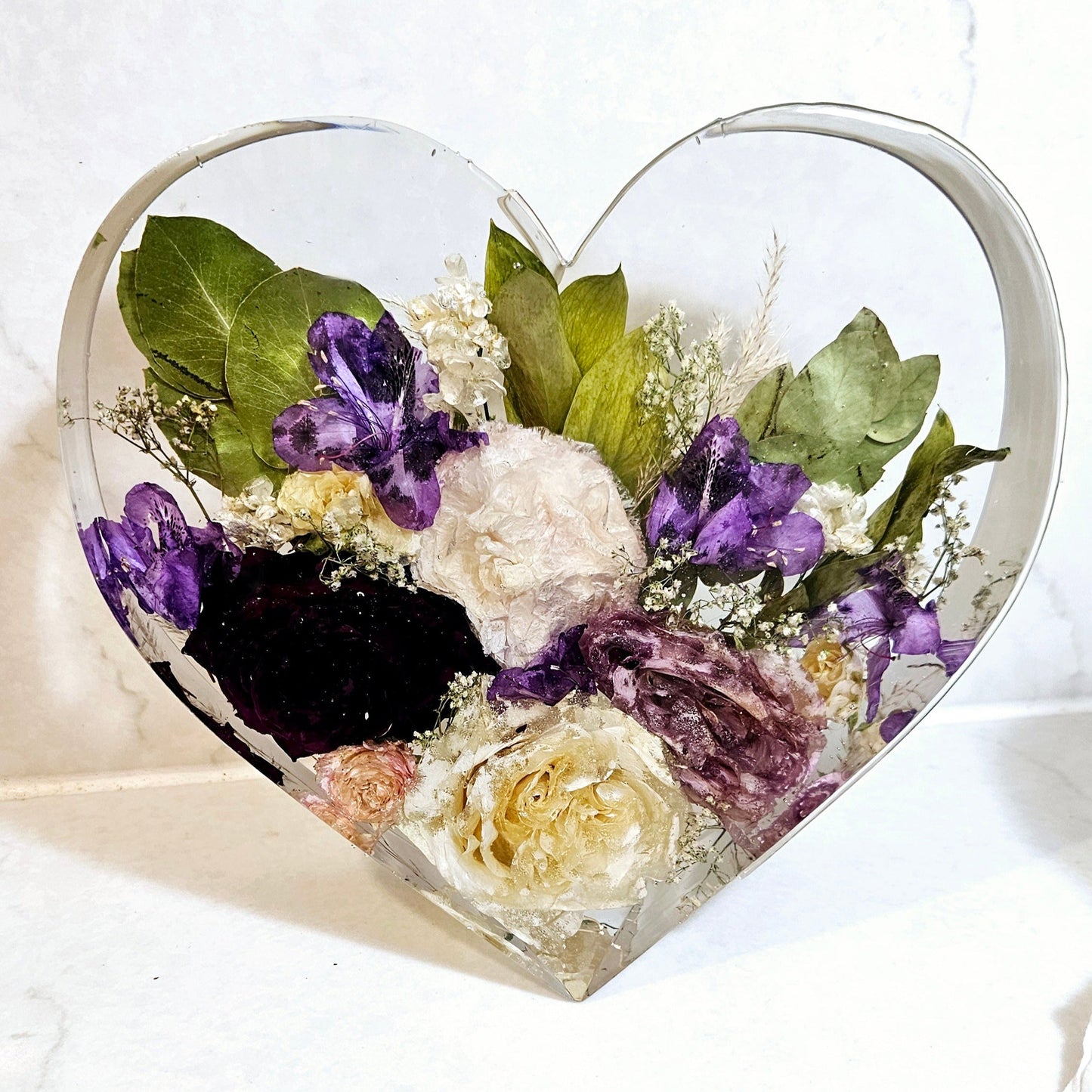 funeral flowers  preserved in a resin in the shape of a standing heart front view
