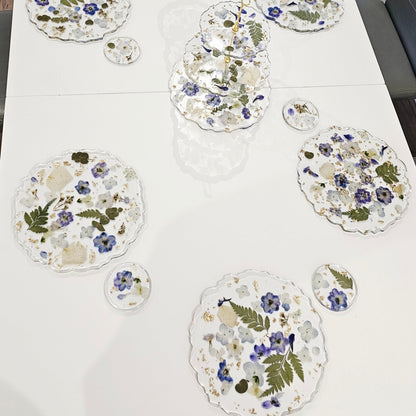 Floral placemats on a white tablecloth with chairs around
