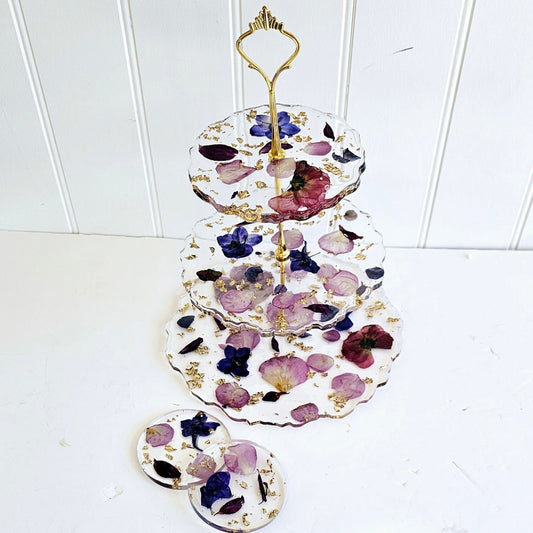 preserved wedding bouquet petals suspended in a 3 tier afternoon tier stand with gold fittings
