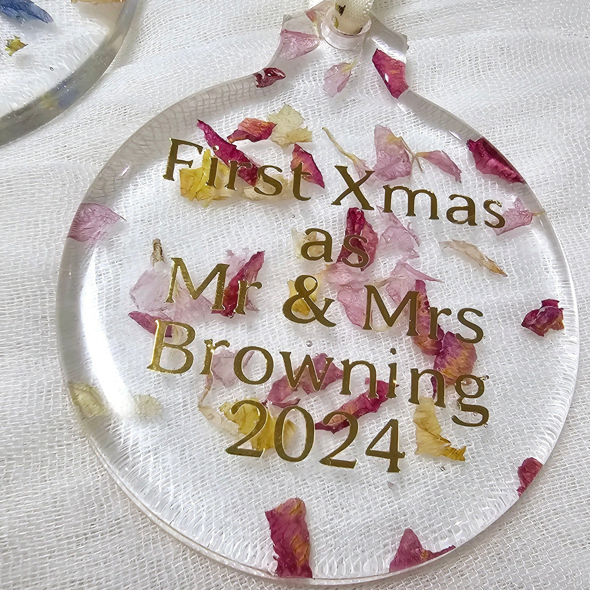 Personalised Christmas ornament with floral design and text on a white background