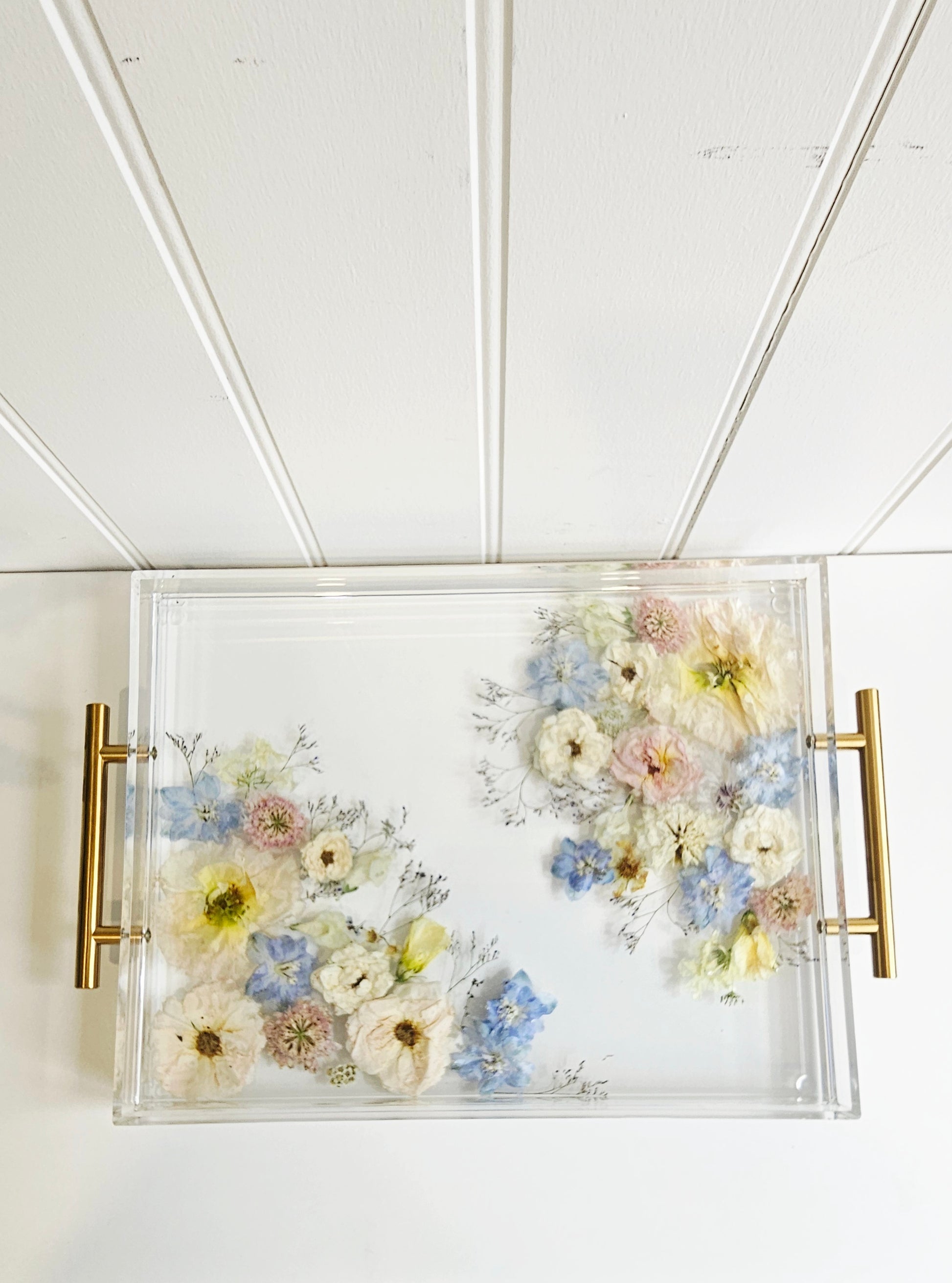 Decorative resin tray with floral design on a white background