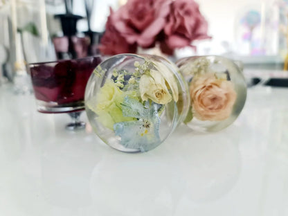 resin furniture knobs with preserved flowers on a blurred background