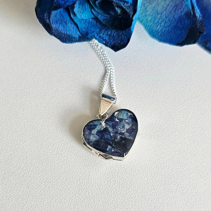Heart-shaped blue pendant on a white background
