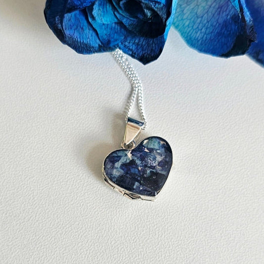 Heart-shaped blue pendant on a white background