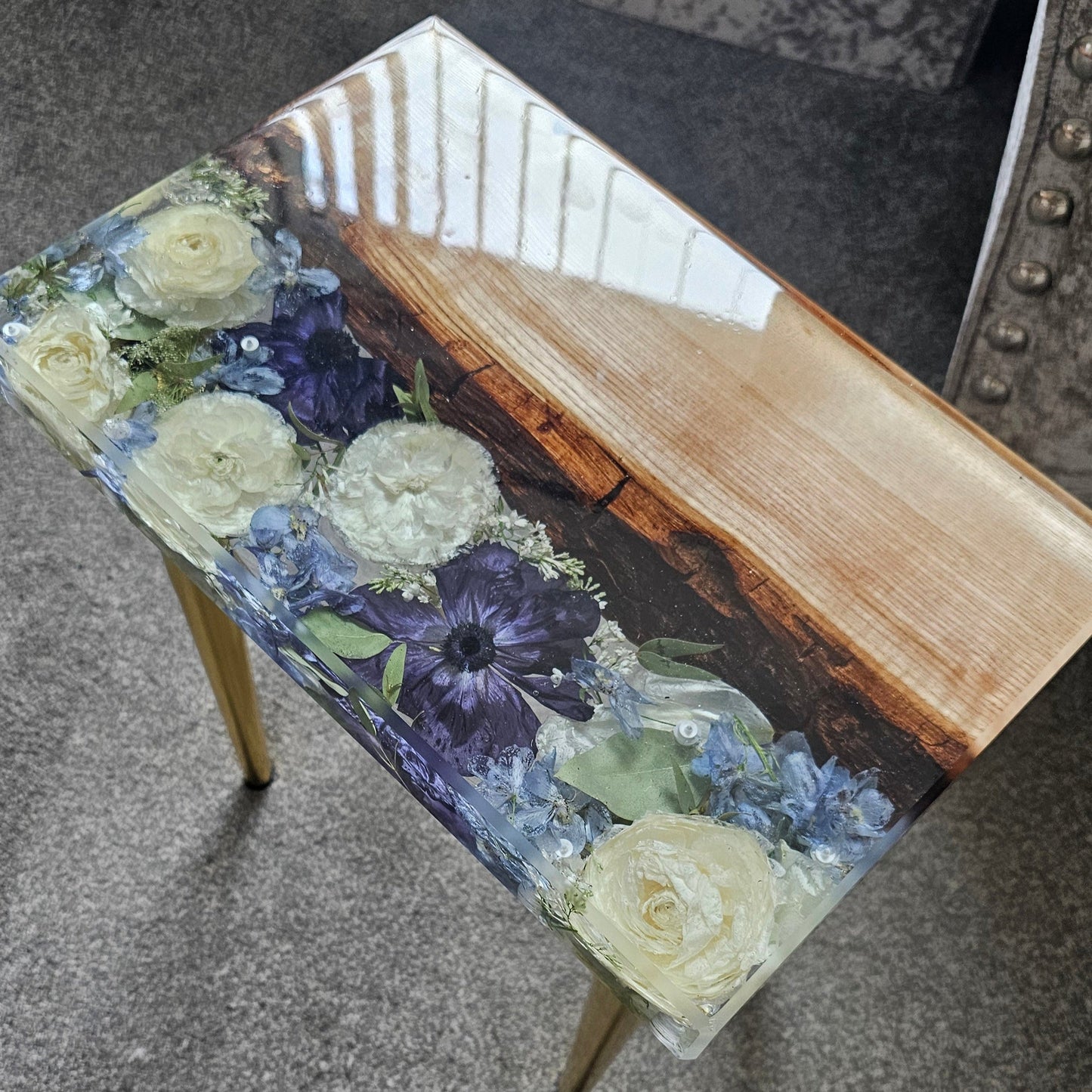 Small table with floral design on a gray surface