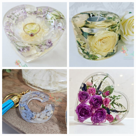 Collage of resin-encased flowers and objects including a heart-shaped container, a candle holder, and keychains.