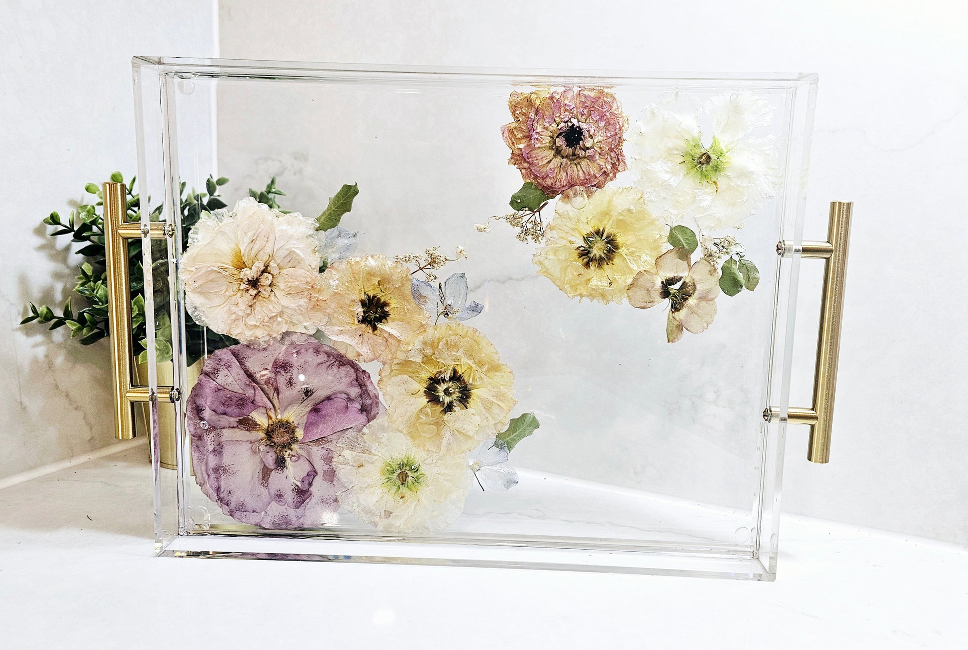 resin tray with pressed flowers on a white background