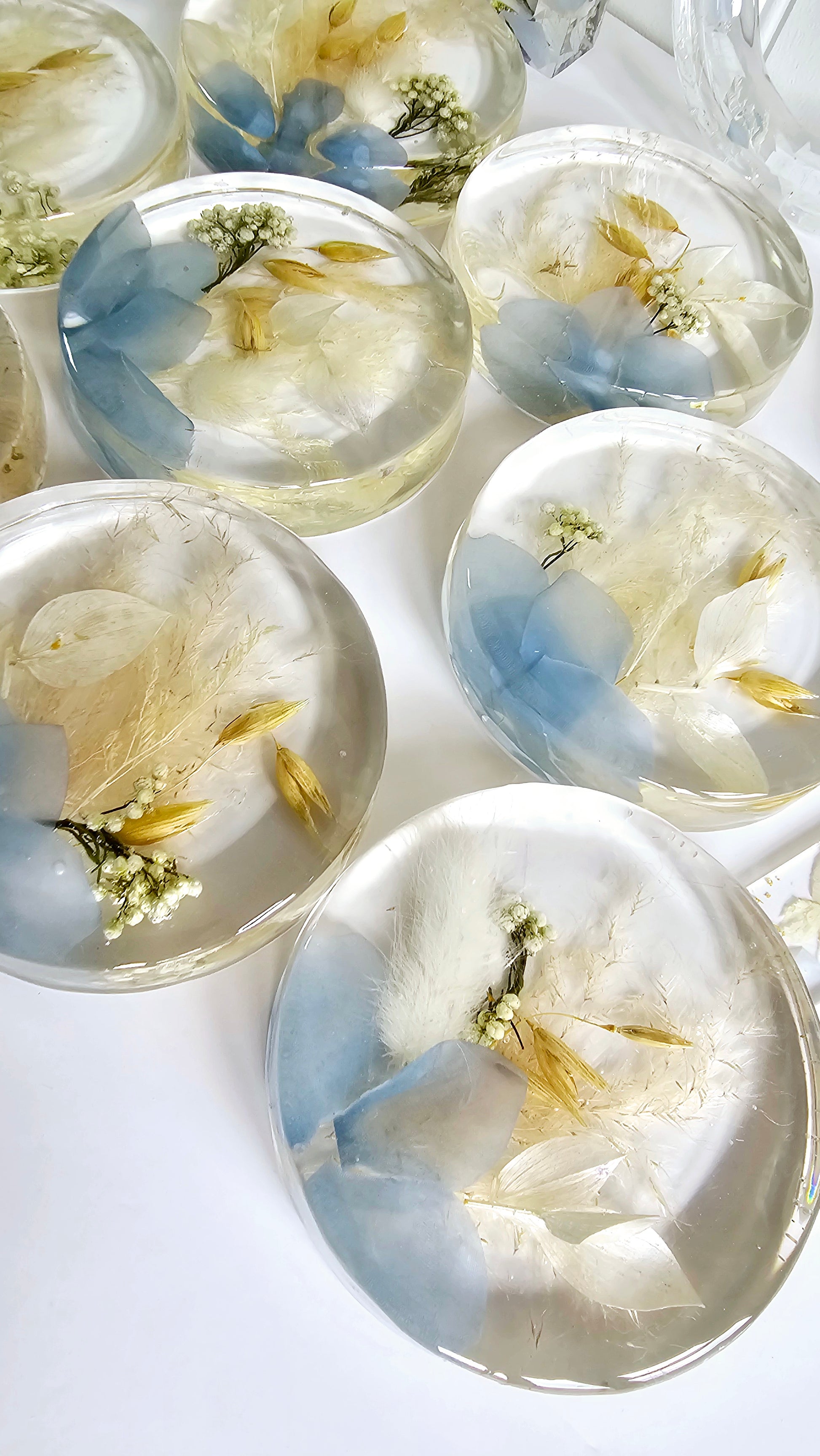 Decorative resin coasters with floral designs on a white background