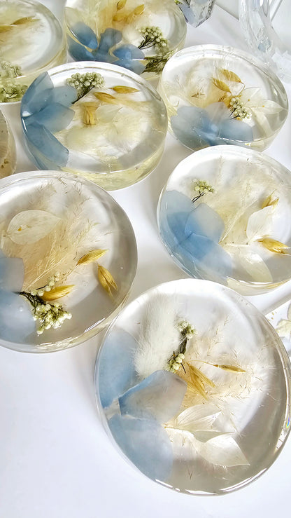 Decorative resin coasters with floral designs on a white background