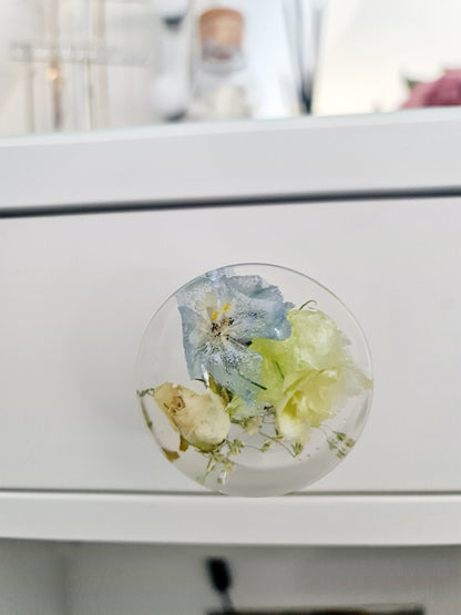 Resin Decorative knob with floral design on a white cabinet
