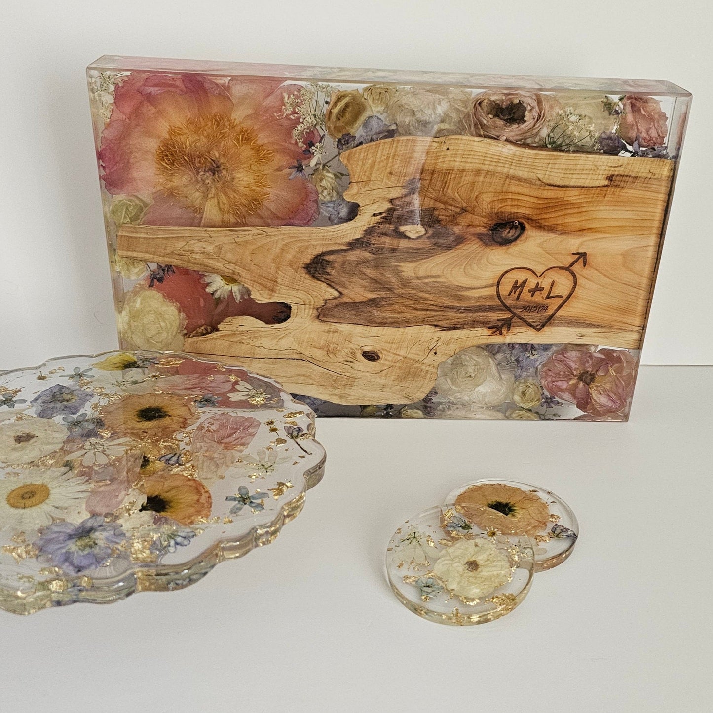 Decorative wooden box with floral design, matching lid, and coasters on a white background