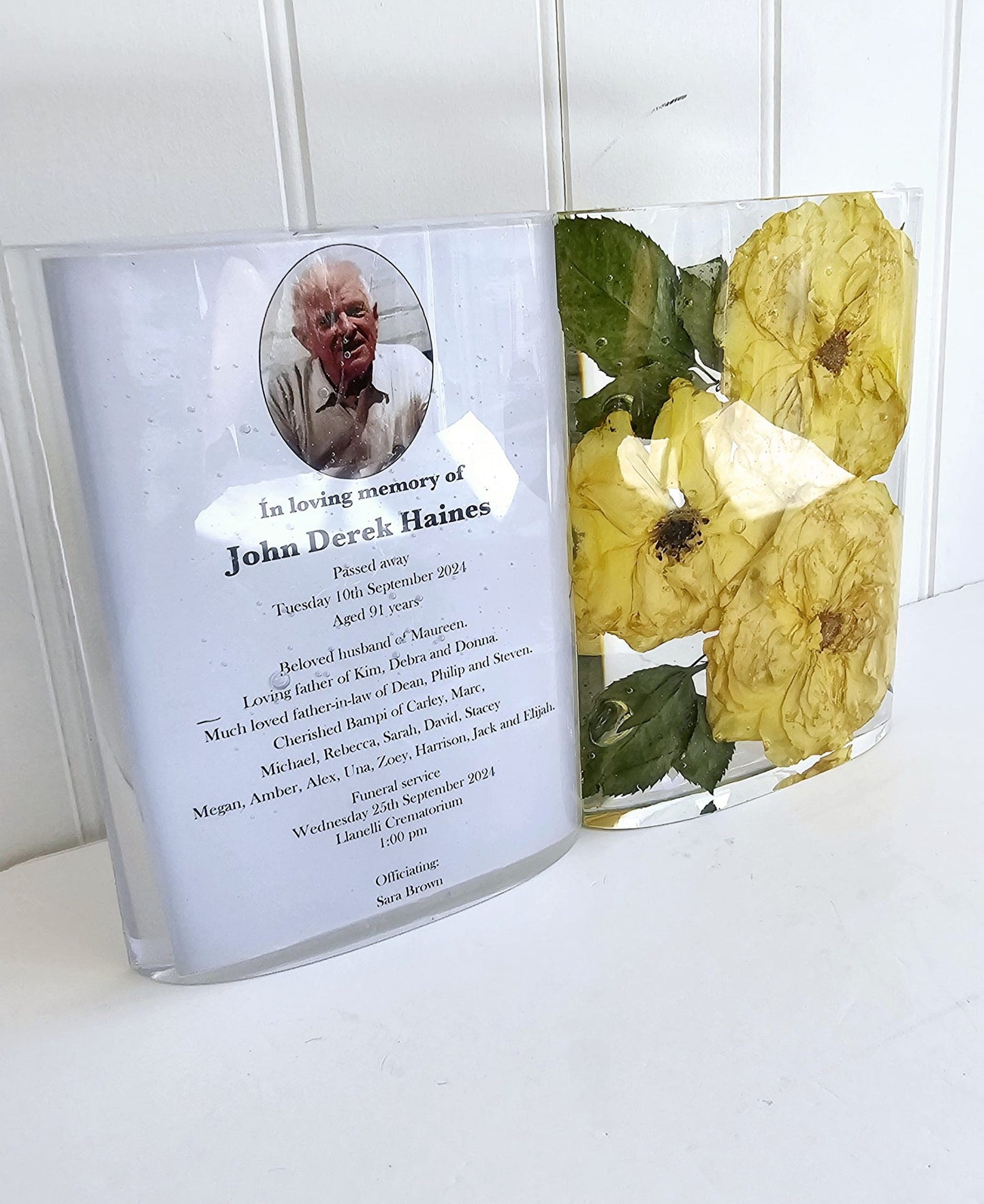 Resin Memorial book with yellow flowers on a white surface