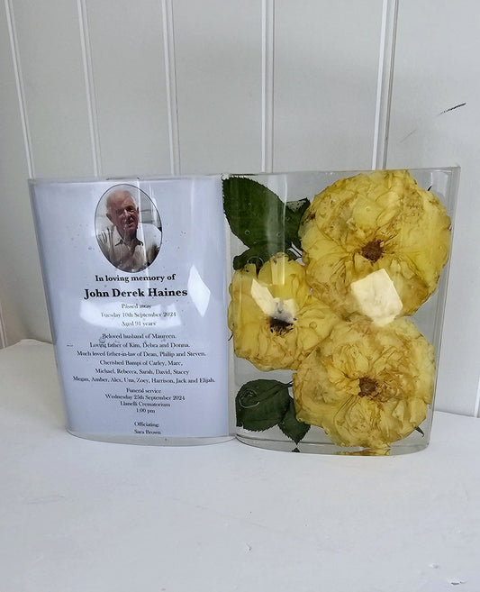 Memorial card with yellow flowers in a resin keepsake ornament  against a white background