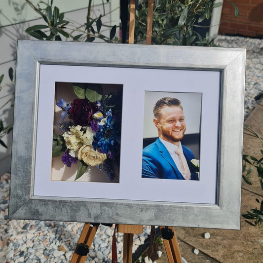 silver frame with funeral flowers preserved on one side and a photo of teh loved one displayed 