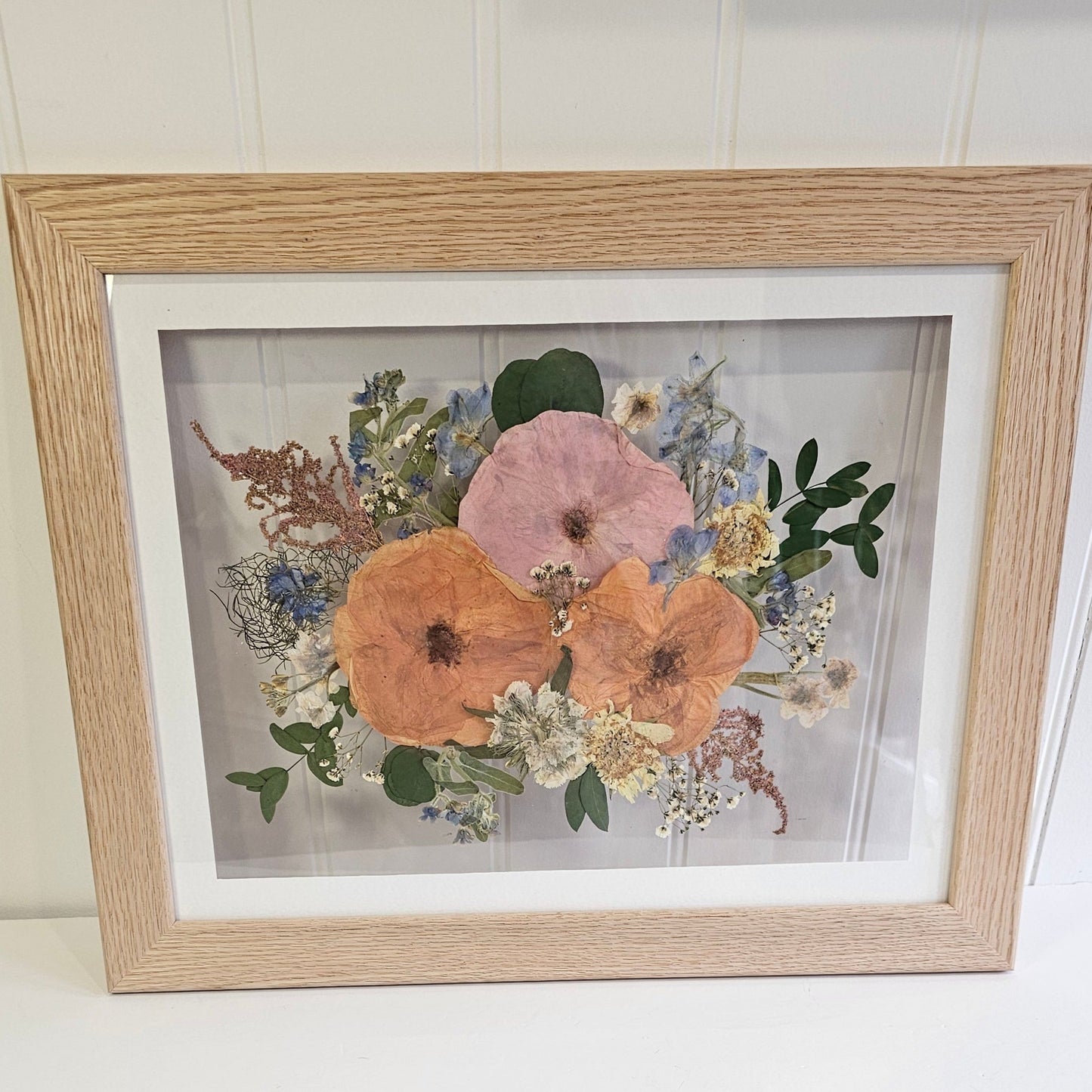 wedding bouquet pressed and framed in a oak frame