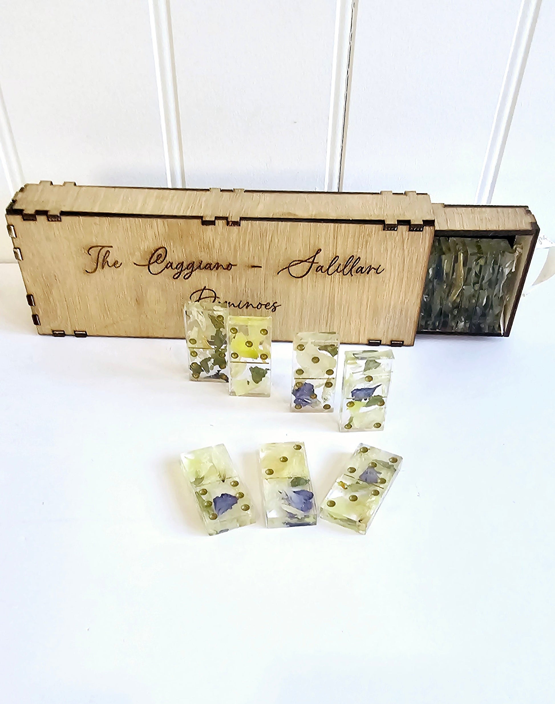 Set of floral soap bars in front of a wooden box labeled 'The Caggiano Salieri Pianoforte'.