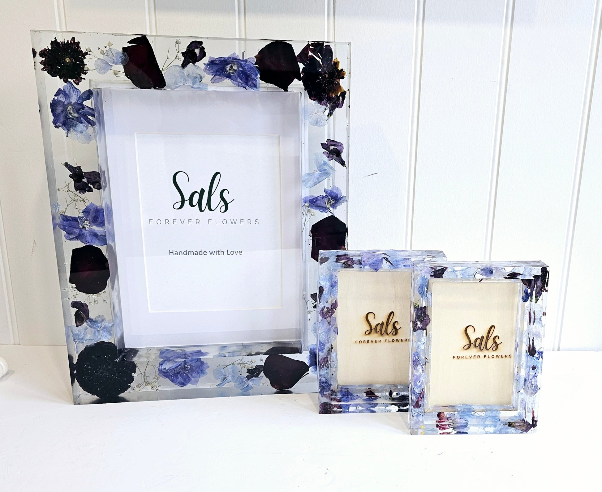 Decorative photo frames with floral design and 'Sals Forever Flowers' branding.