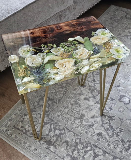 Resin Flower Preservation Table with floral design and wood  on a patterned rug