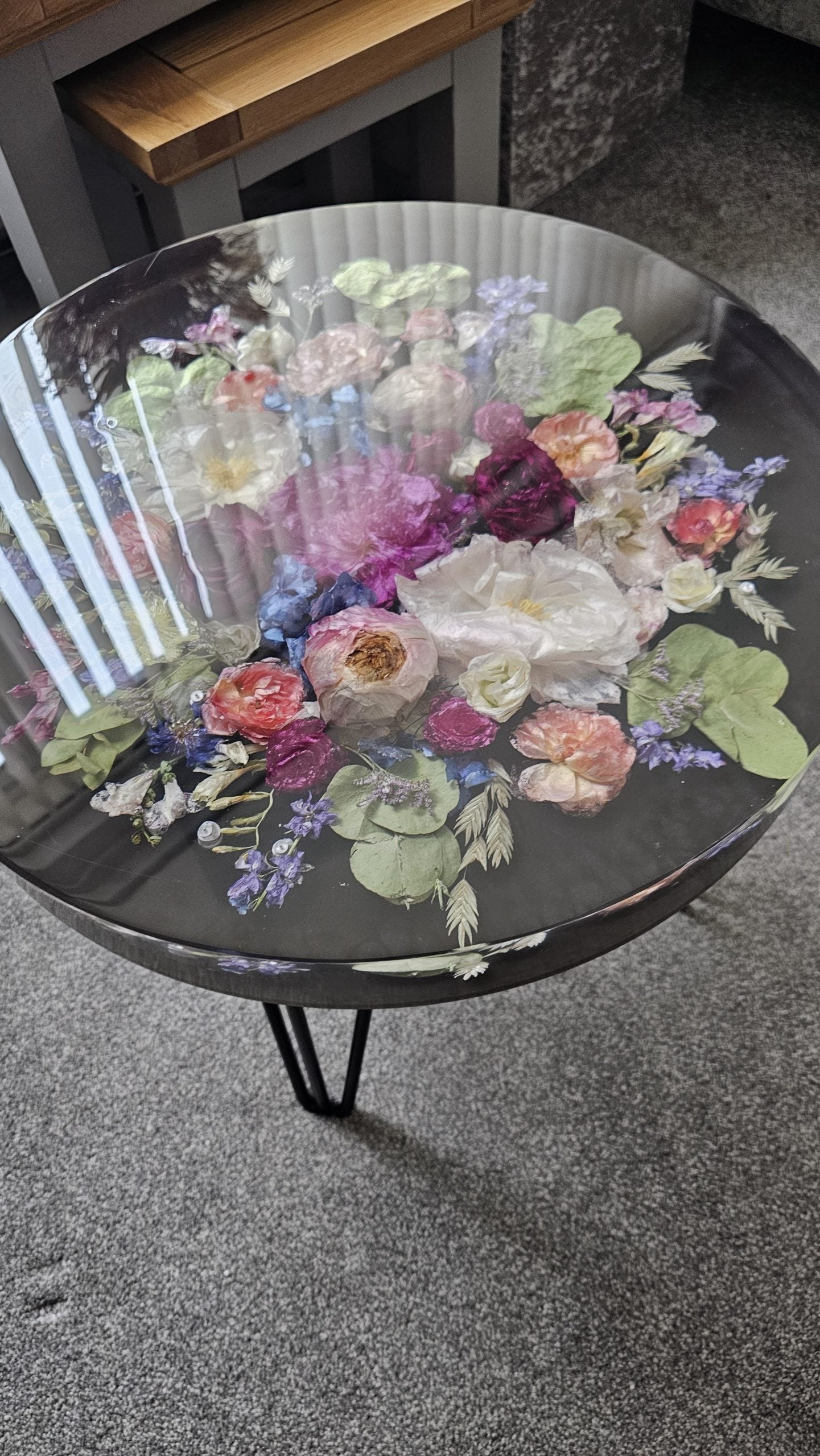 Round table with floral design on a gray floor