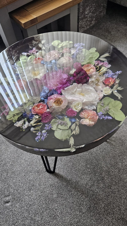 Round table with floral design on a gray floor