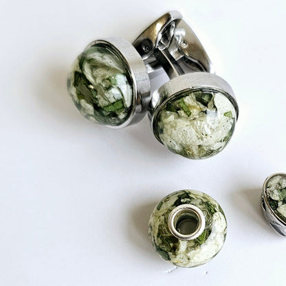 silver bead charm for bracelet and cufflinks made with resin and green and white petals 