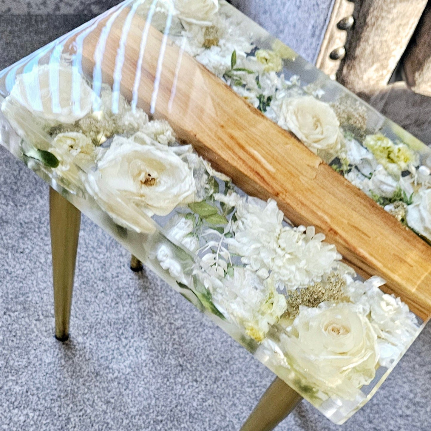 Small table with floral design on a gray floor