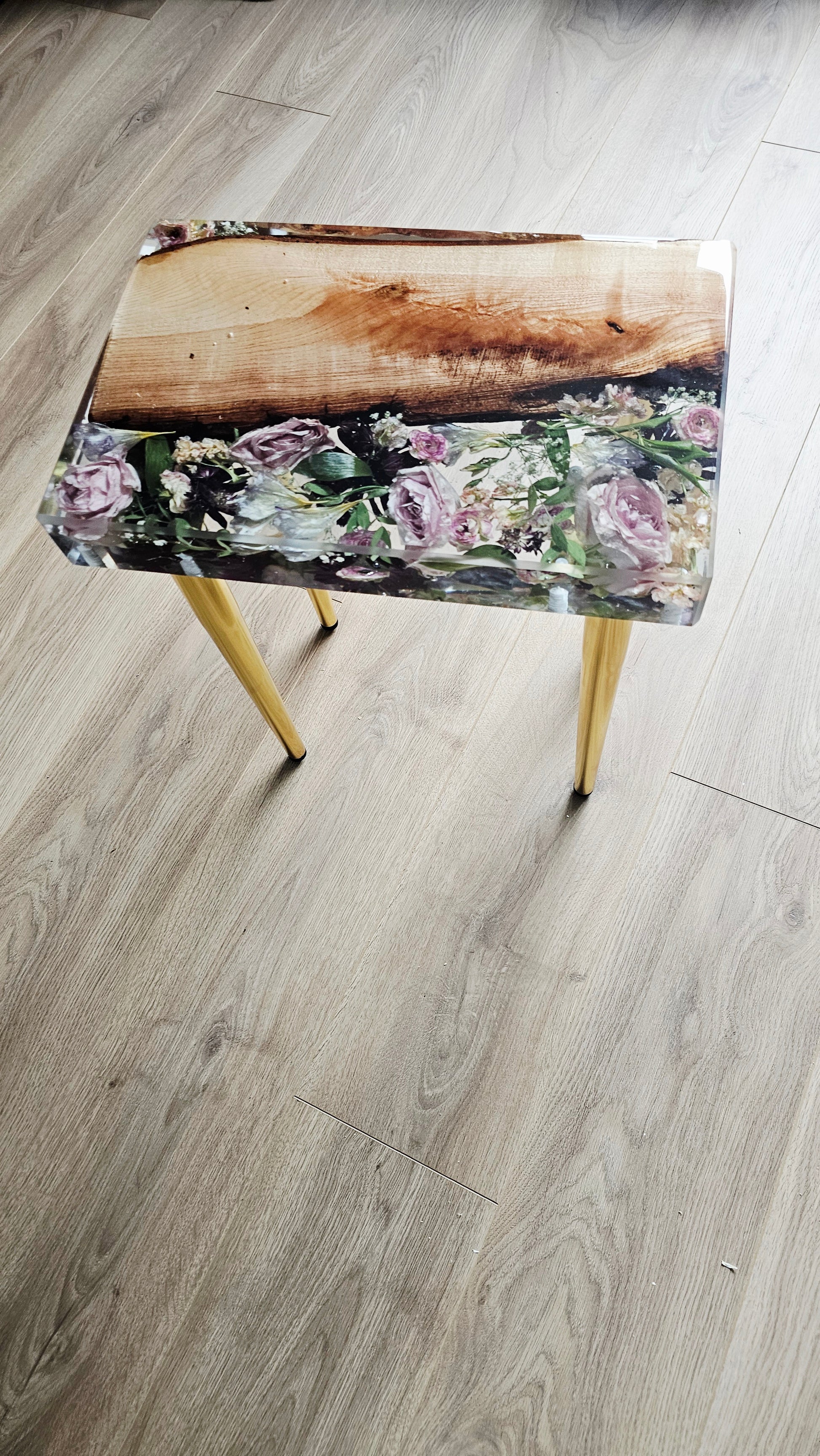 Table with floral design on a wooden floor