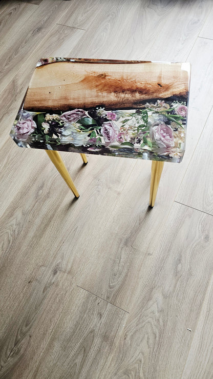 Table with floral design on a wooden floor